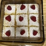 lemon coconut bars served on white dishes